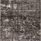 Rectangular area rug with dense black, gray, and white abstract speckle pattern.