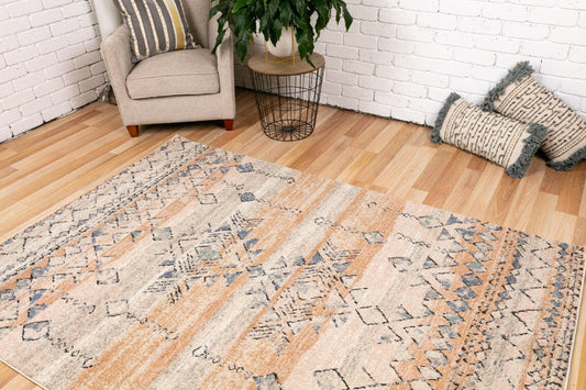 Geometric area rug in rust, dark beige, and blue, framed border on short textured pile.