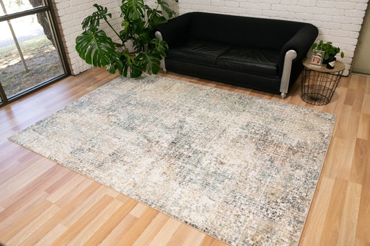Modern area rug with abstract sky grey and cream pattern on light wood floor