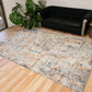 Multi-color area rug with distressed abstract pattern in light blue and beige