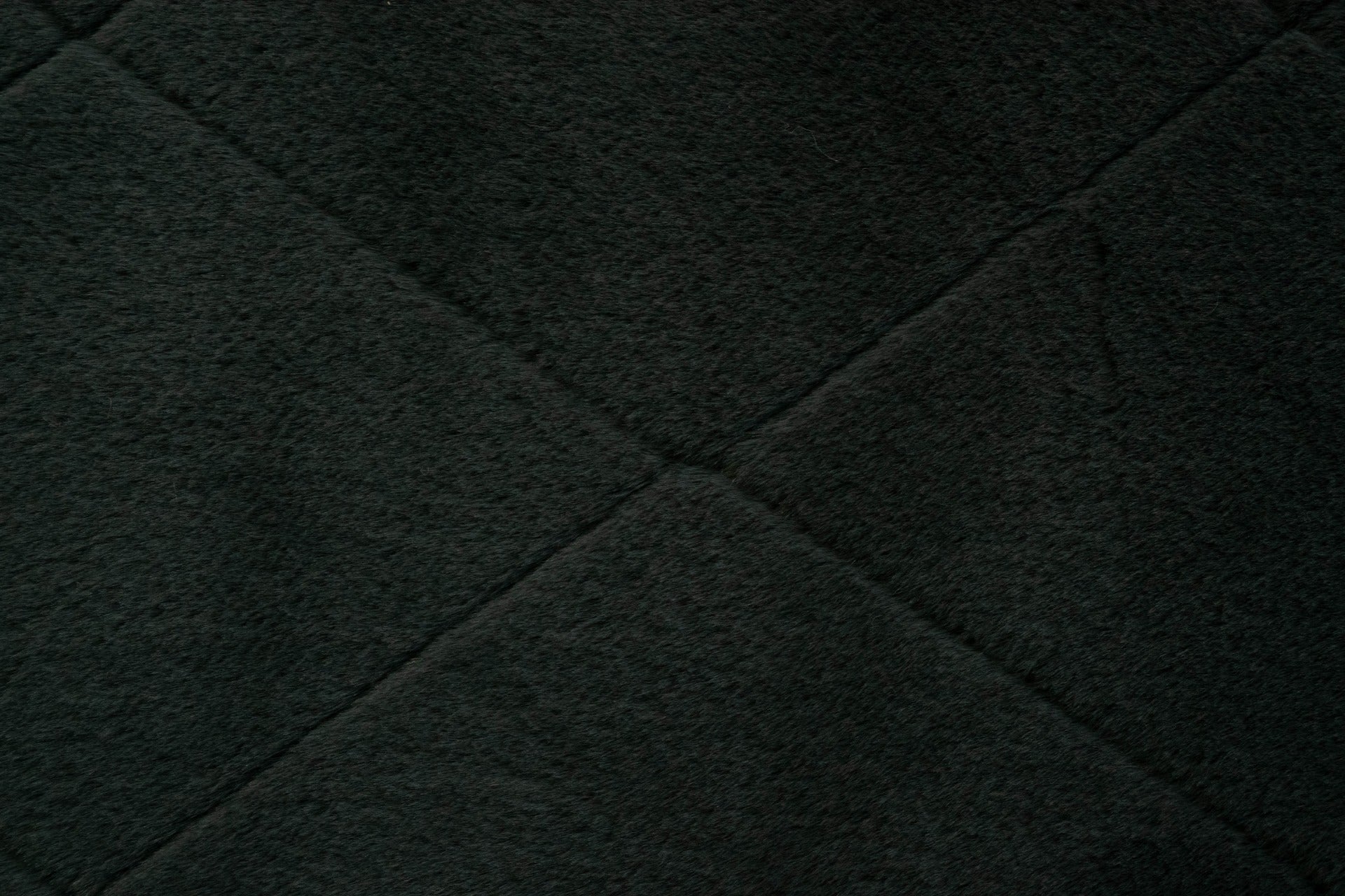 Charcoal plush rug texture with diamond stitch detail