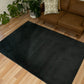 Charcoal shag rug with dark velvety pile and diamond pattern