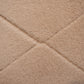 Soft pink shag rug close-up with diamond texture and stitched seam