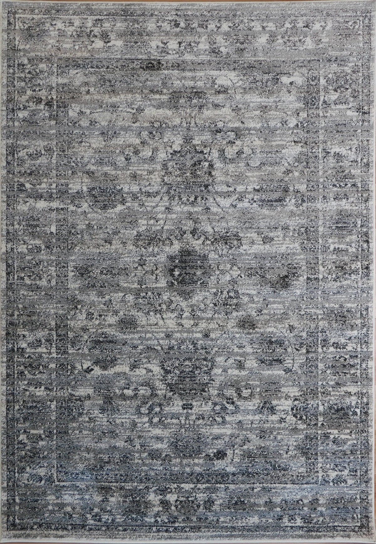 Grey area rug with distressed abstract pattern and border edge detail