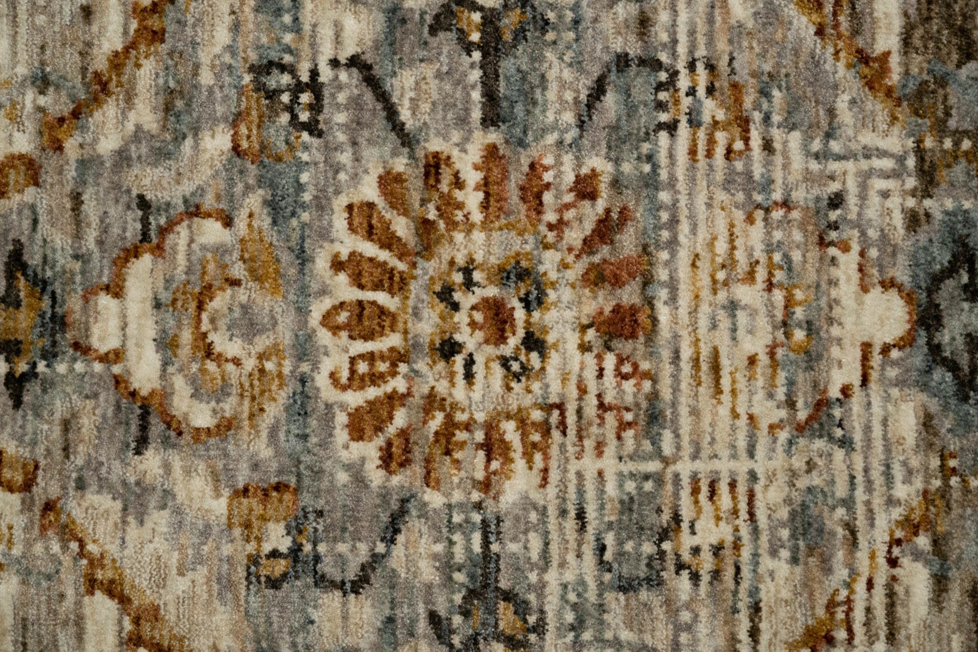 Close-up of multi-colored vintage rug texture with ornate floral motif