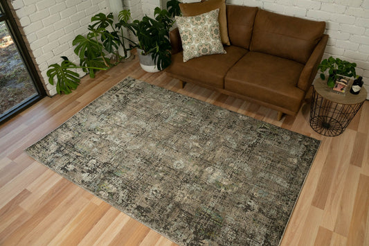 Distressed area rug with rectangular shape, mottled gray-green pattern